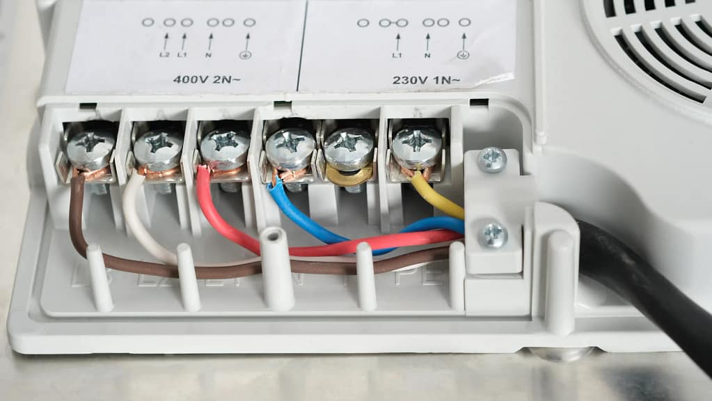 Heat pump wiring connections showing color-coded wires and terminal blocks.