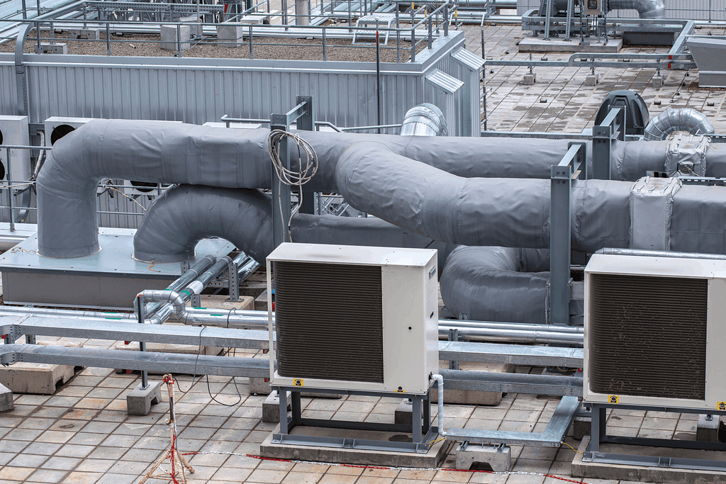 HVAC system with insulated pipes and outdoor units on a commercial rooftop